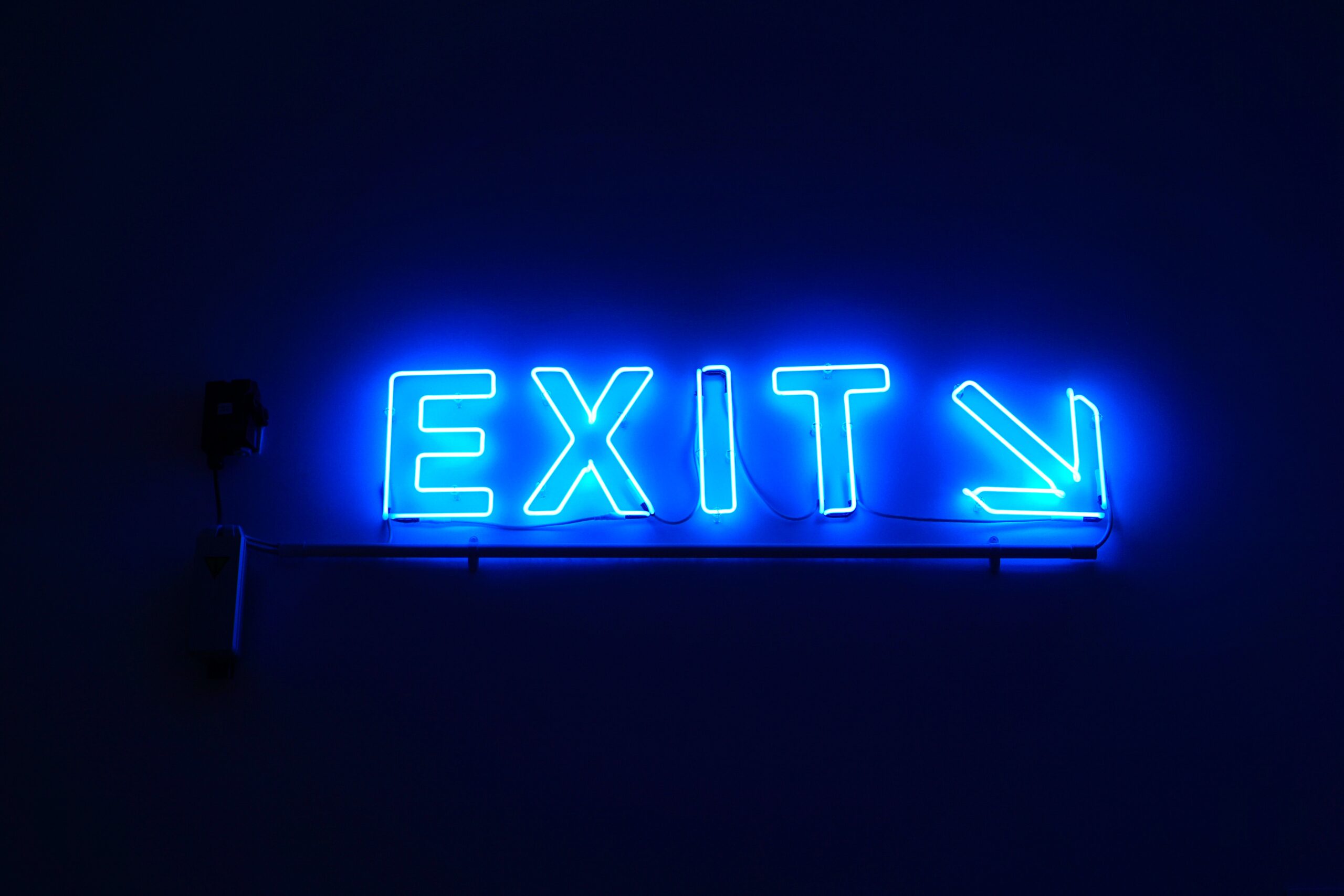 neon blue "exit" sign