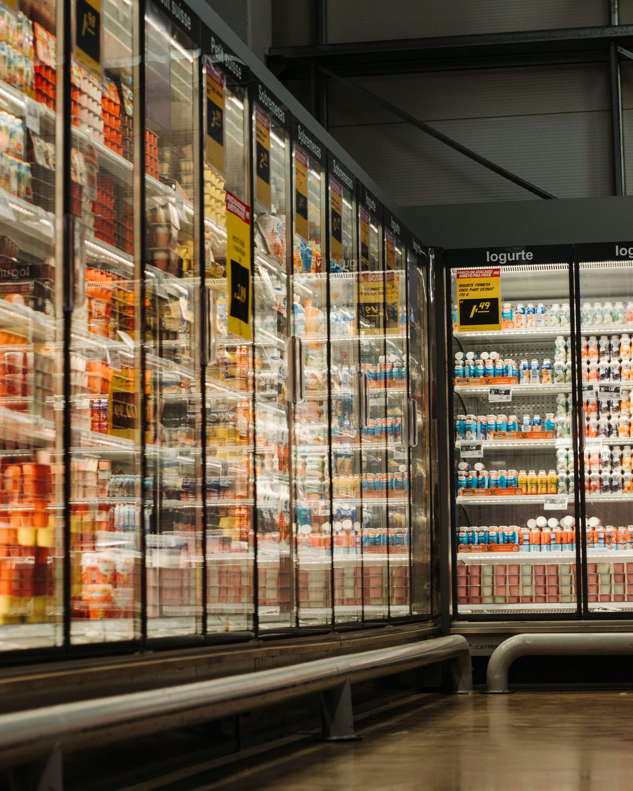grocery store aisle with cold cases full of products