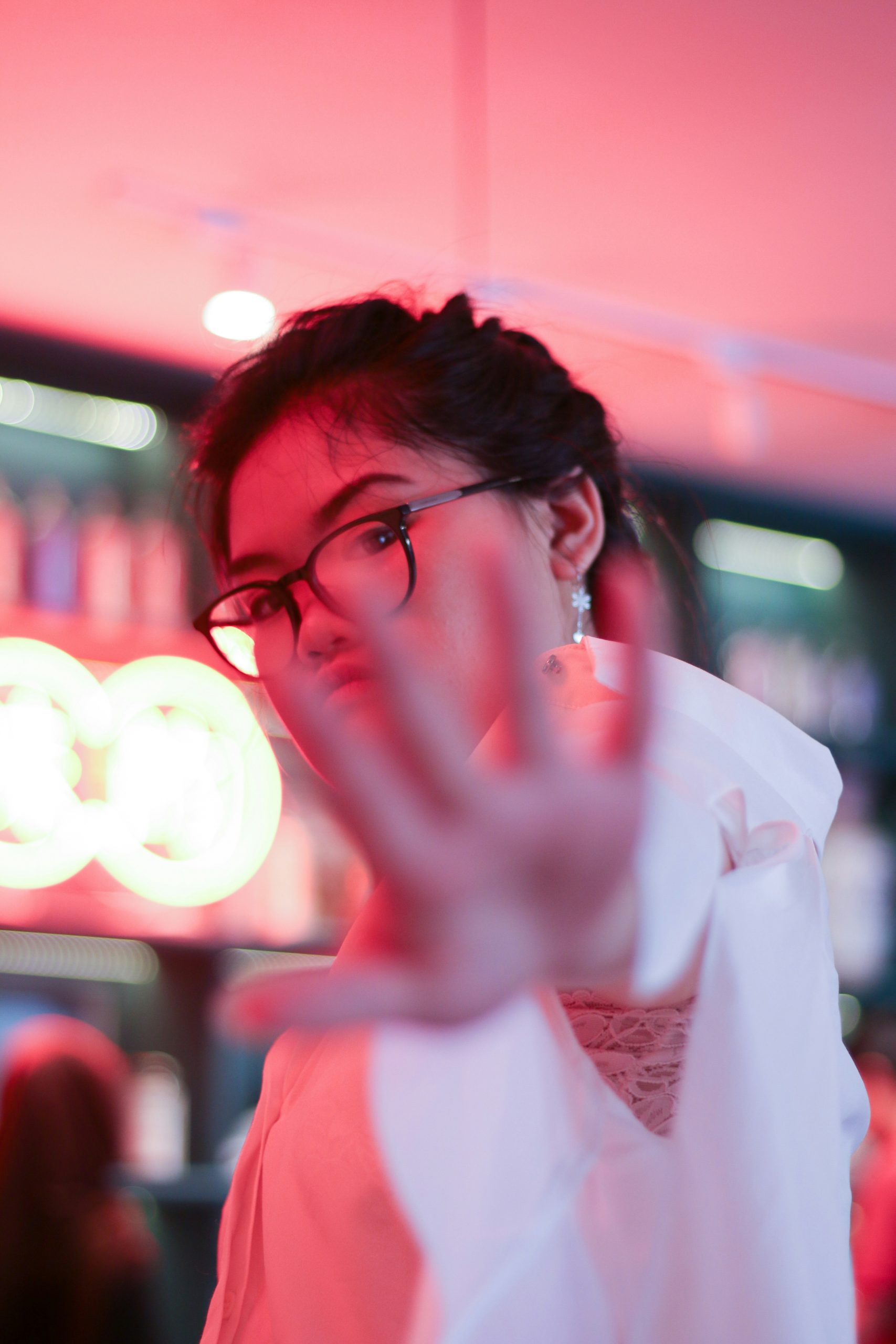 Asian woman making "talk to the hand" gesture