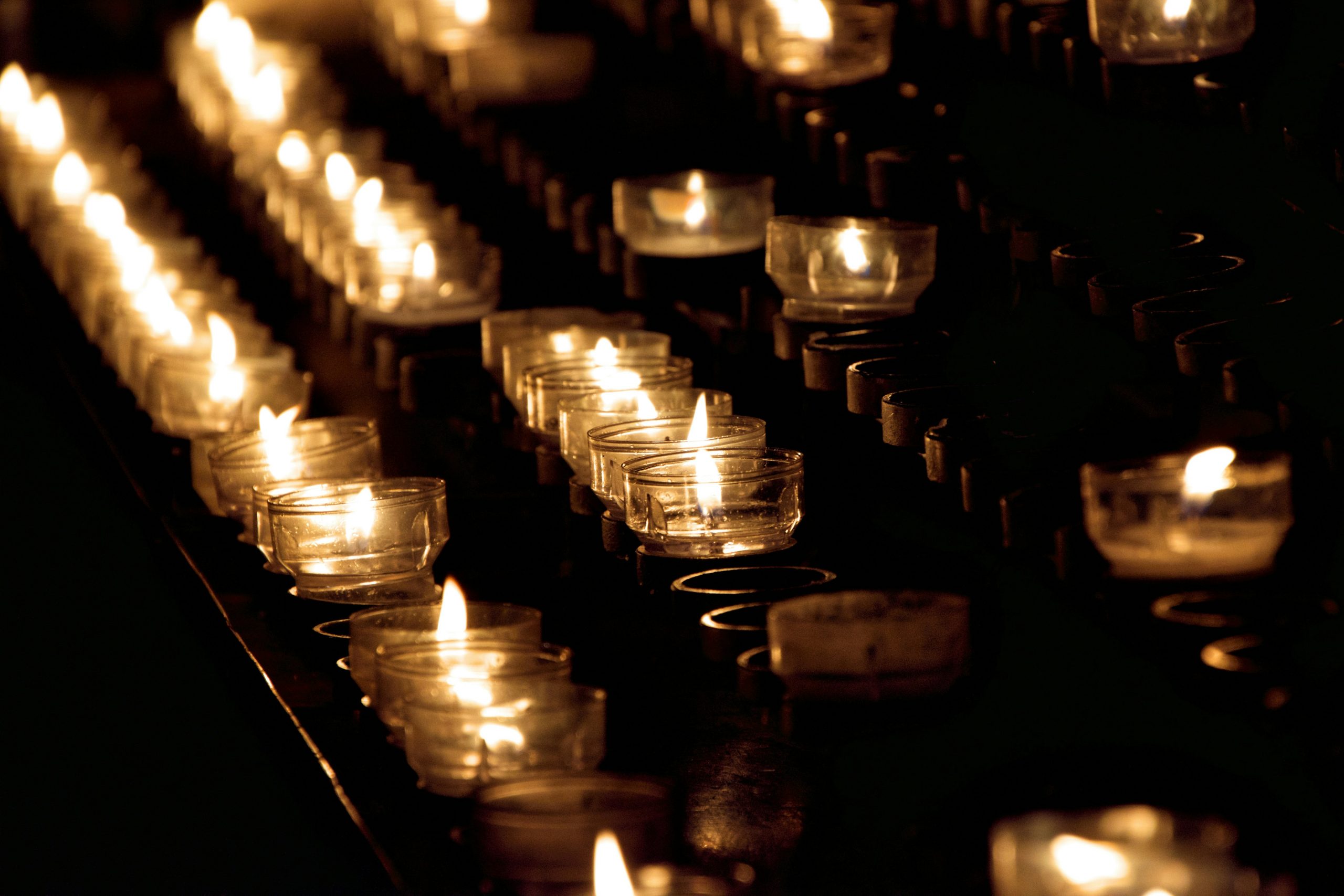 rows of lit tea lights